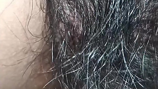 Close up view on a hairy and creamy pussy