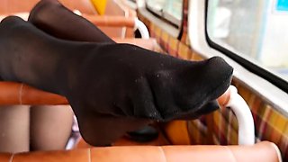 Stinky black pantyhose feet in old school bus foot wors