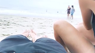 Filming an anal scene on the beach in front of passersby