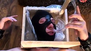 Sexy slender brunette dominatrix punishes her masked slave