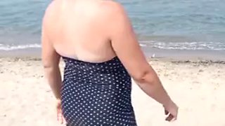 Showing my big tits on the public beach