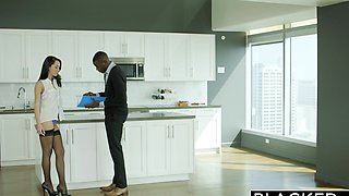 Brunette with long hair fucks in the kitchen with a black guy