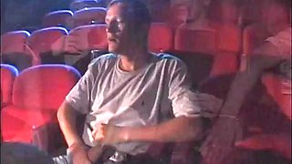 Blonde and brunette gang fucked in a porn theater