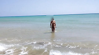 On a nudist beach I meet a guy masturbating and I help him