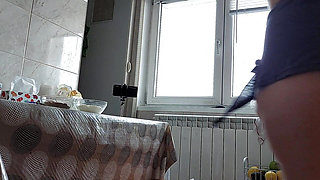 Brunette hairy pussy prepares breakfast naked in the kitchen.