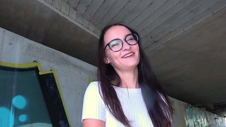 Glasses girl strokes that dick and takes it under the bridge