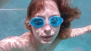 Skinny blonde ukrainian teen Clarise reveals her small tits in the pool