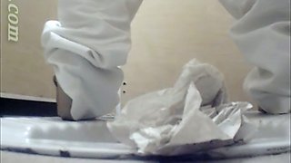 White chick in white pants pisses in the public toilet room on cam