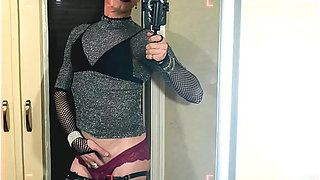 A young femboy films herself in the mirror stroking her clitoris in red panties, high heels, a mask, and ears.