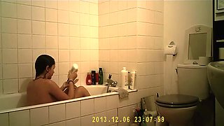 Brunette cutie enjoys a hot shower in the bathroom