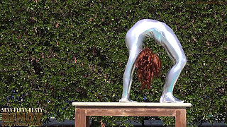 Bending in a Silver Spandex Suit