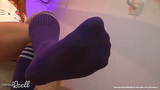Mistress Sucking Lollypop with Long Socks on Her Feet