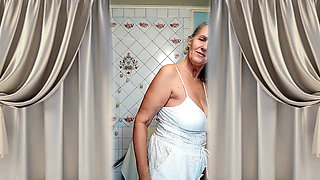 A Mature Ukrainian Woman Shows off Her Figure and Poses for the Camera at Home