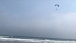 Busty MILF In Green Bikini Handjobs Her Partner On A Public Beach