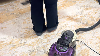 Curvy woman cleaning the house in trousers
