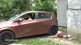 Mistress Jenna Stands on the Slave with a Car While Smoking in the Slave's Mouth