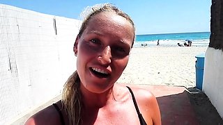 Outdoor solo masturbation scene with curly blonde