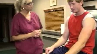 Milf Carey Riley strokes a young guys dick in the office